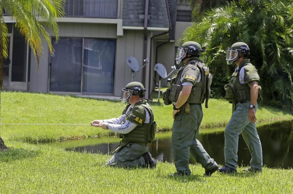 <p>Bomb disposal officers check for bombs at an apartment complex of a suspect linked to the fatal shootings at an Orlando nightclub, Sunday, June 12, 2016, in Fort Pierce, Fla. (AP Photo/Alan Diaz) </p>