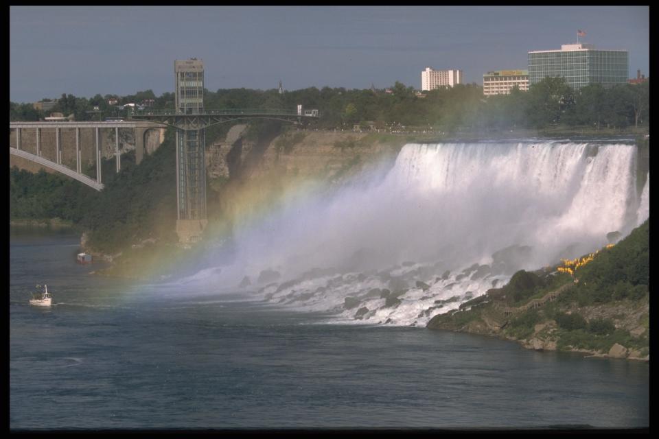 Niagara Falls with a faint rainbow in the foreground.