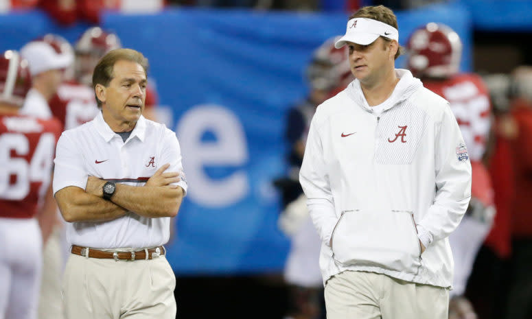 Nick Saban talking to Lane Kiffin before a game.