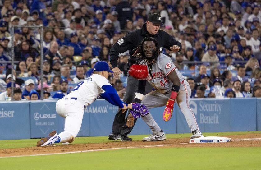 LOS ANGELES, CA - MAY16, 2024: Cincinnati Reds shortstop Elly De La Cruz (44) steals third base as Los Angeles Dodgers third baseman Enrique Hernandez (8) was pulled off the base in the fifth inning at Dodger Stadium on May 16, 2024 in Los Angeles, California.(Gina Ferazzi / Los Angeles Times)