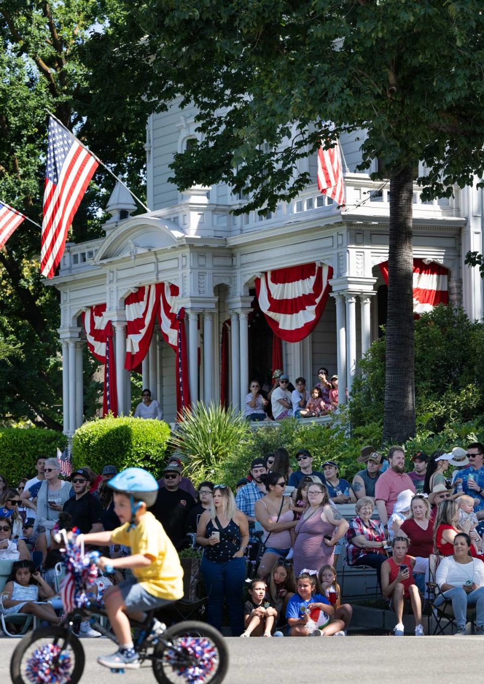 People watch the Independence Day Parade outside McHenry Mansion on I Street in Modesto, Calif., Tuesday, July 4, 2023. Andy Alfaro/aalfaro@modbee.com