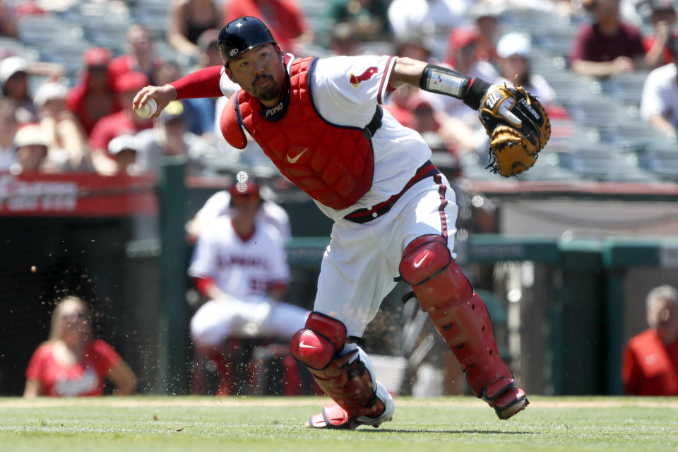 Los Angeles Angels catcher Kurt Suzuki throws out Oakland Athletics' Matt Chapman on an infield ground ball during the fourth inning of a baseball game in Anaheim, Calif., Saturday, July 31, 2021. (AP Photo/Alex Gallardo)