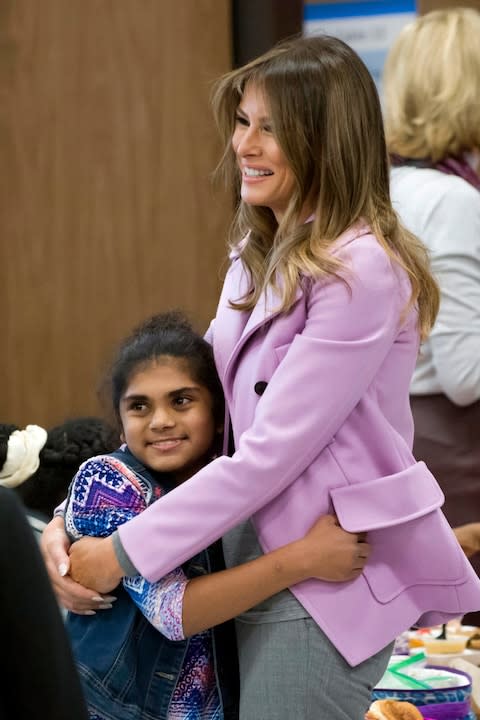 First lady Melania Trump hugs student Yumna Ali while visiting Orchard Lake Middle School in West Bloomfield, Mich - Credit: AP