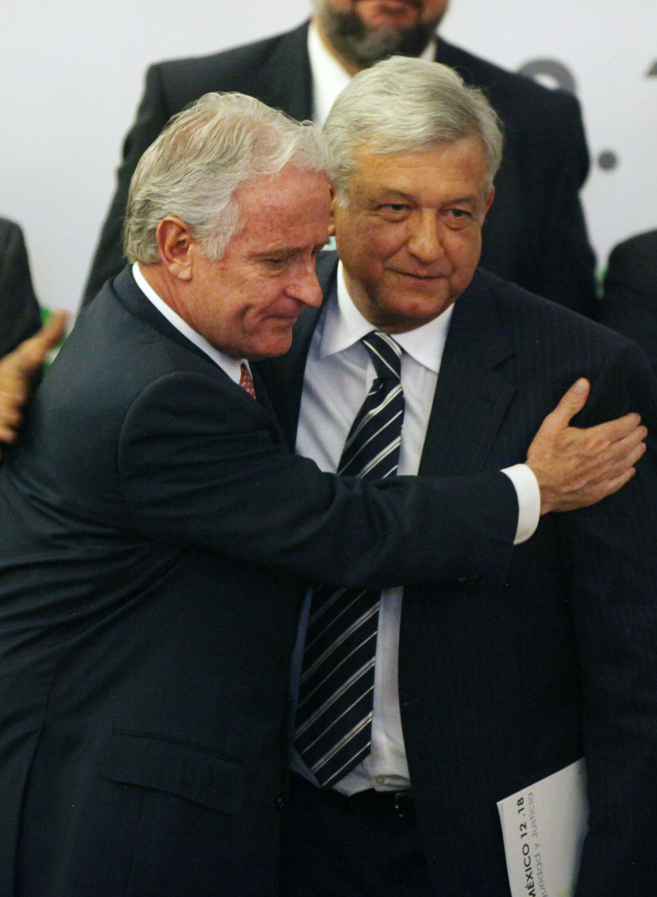 Presidential candidate Andres Manuel Lopez Obrador, of the Democratic Revolution Party (PRD), right, greets Mexican businessman Alejandro Marti, during an event organized by Civil Society Mexico SOS to deliver a document about justice and security, in Mexico City, Monday, April 2, 2012. The four candidates for Mexico's presidency officially launched their campaigns for the July 1 election on Friday, all of them promising change. (AP Photo/Alexandre Meneghini)