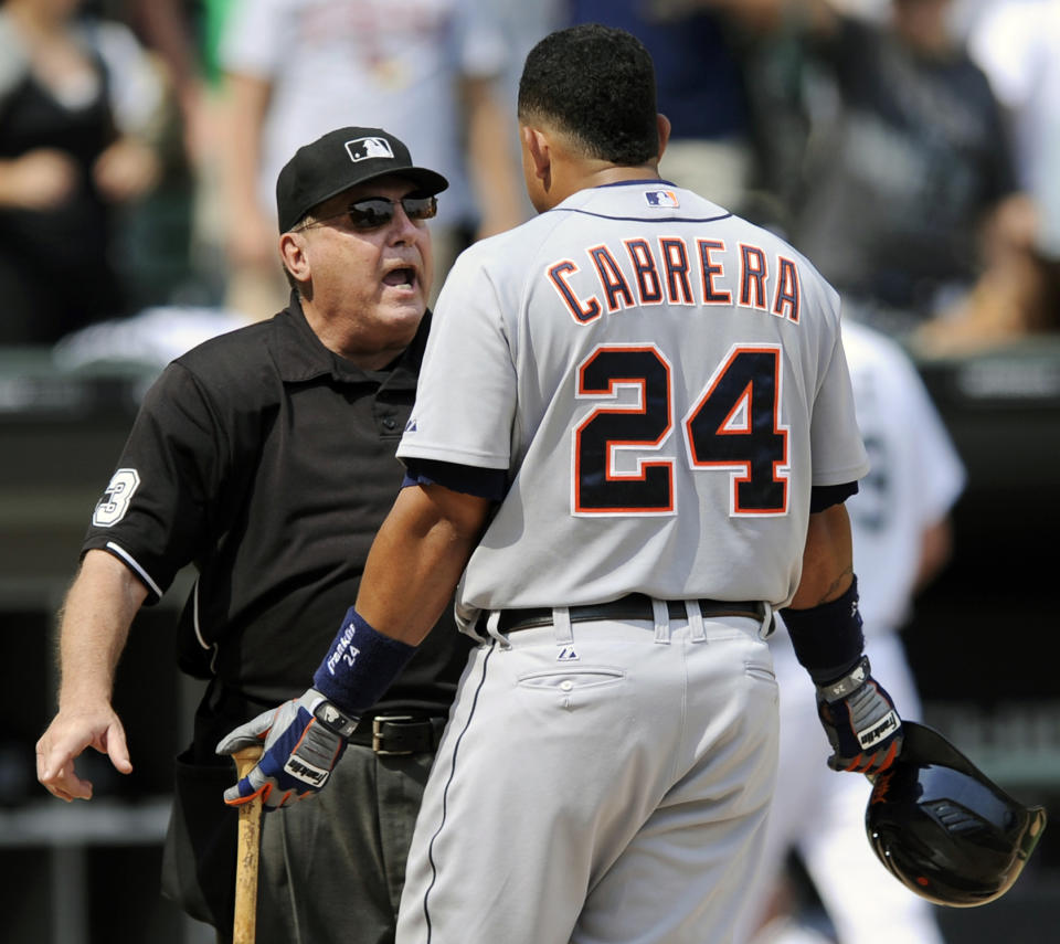 FILE - In this Wednesday, July 27, 2011 file photo, Detroit Tigers' Miguel Cabrera right, argues with home plate umpire Derryl Cousins after striking out against the Chicago White Sox during the seventh inning of a baseball game in Chicago. Former major league umpire Derryl Cousins, who worked three World Series during a career that lasted over three decades, has died. He was 74. Craig Cousins said his brother died at home Monday, Oct. 19, 2020 after a bout with cancer. (AP Photo/Paul Beaty, File)