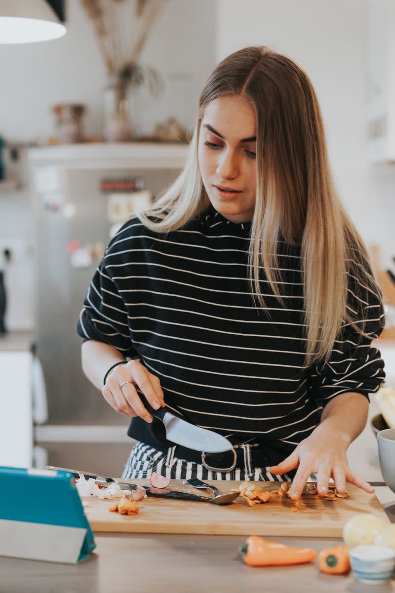 A woman preparing ingredients for a meal