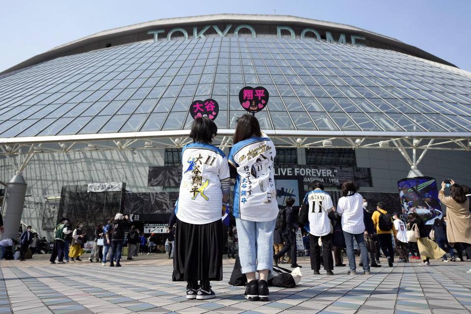 Fans of Japan's Shohei Ohtani cheer prior to the Pool B game between Japan and China at the World Baseball Classic (WBC) at the Tokyo Dome Thursday, March 9, 2023, in Tokyo. Japanese baseball player Shohei Ohtani is arguably the game's best player. But he's more than just a baseball player. He's an antidote for many in his native country. (AP Photo/Eugene Hoshiko)