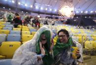 <p>Spectators wait in the rain for the start of the Summer Olympics closing ceremony inside Maracana stadium in Rio de Janeiro, Brazil, Sunday, Aug. 21, 2016. (AP Photo/Jae C. Hong) </p>