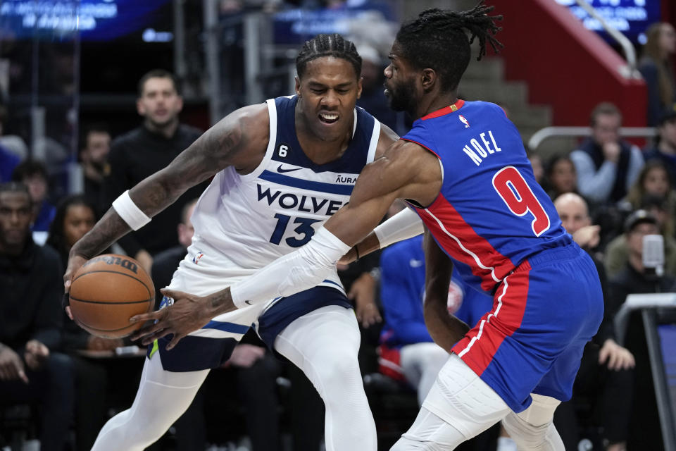Detroit Pistons' Nerlens Noel (9) defends Minnesota Timberwolves forward Nathan Knight (13) in the second half of an NBA basketball game in Detroit, Wednesday, Jan. 11, 2023. (AP Photo/Paul Sancya)