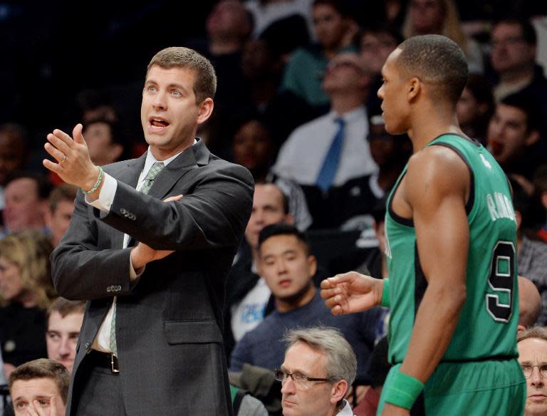 Brad Stevens (L), head coach of the Boston Celtics, with Rajon Rondo during a NBA game against on March 21, 2014 at the Barclays Center in the Brooklyn borough of New York