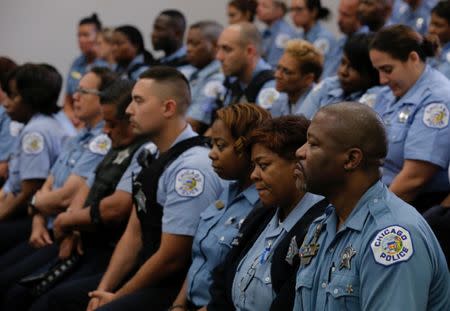 Chicago Police officers attend a news conference held by Superintendent Eddie Johnson announcing the department's plan to hire nearly 1,000 new police officers in Chicago, Illinois, U.S., September 21, 2016. REUTERS/Jim Young