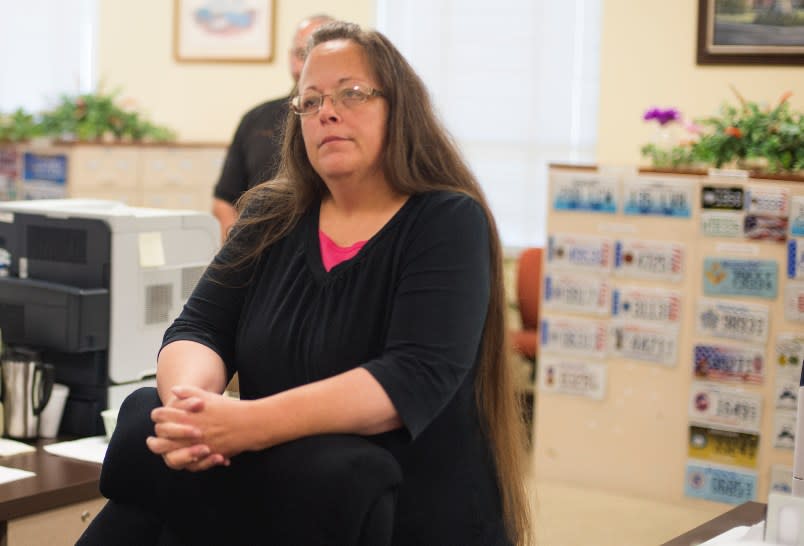 MOREHEAD, KY – SEPTEMBER 2: Kim Davis, the Rowan County Clerk of Courts, listens to Robbie Blankenship and Jesse Cruz as they speak with her at the County Clerks Office on September 2, 2015 in Morehead, Kentucky. Citing a sincere religious objection, Davis, an Apostolic Christian, has refused to issue marriage licenses to same sex couples in defiance of a Supreme Court ruling. (Photo by Ty Wright/Getty Images)