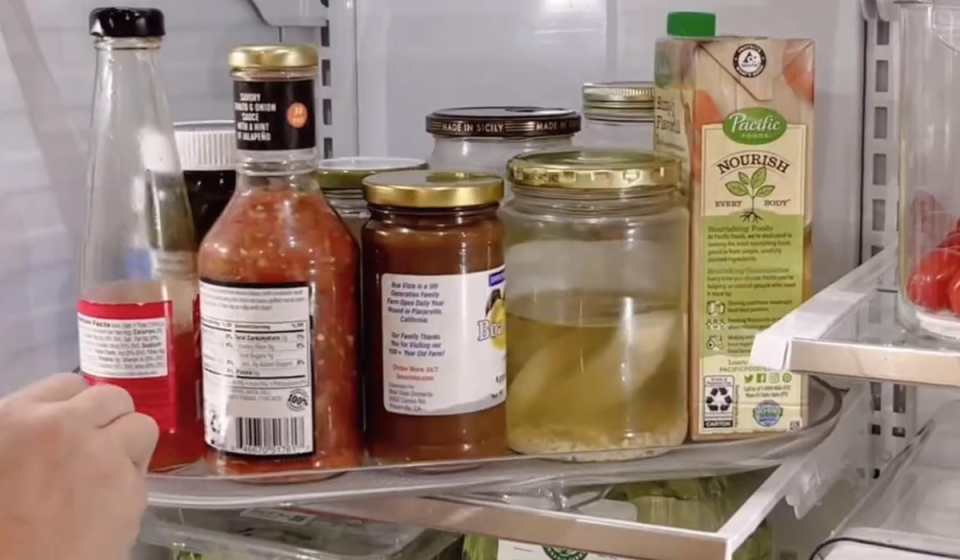 someone turning the lazy susan in a fridge