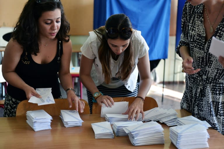 Polling station officials count the ballots at a polling station in Athens