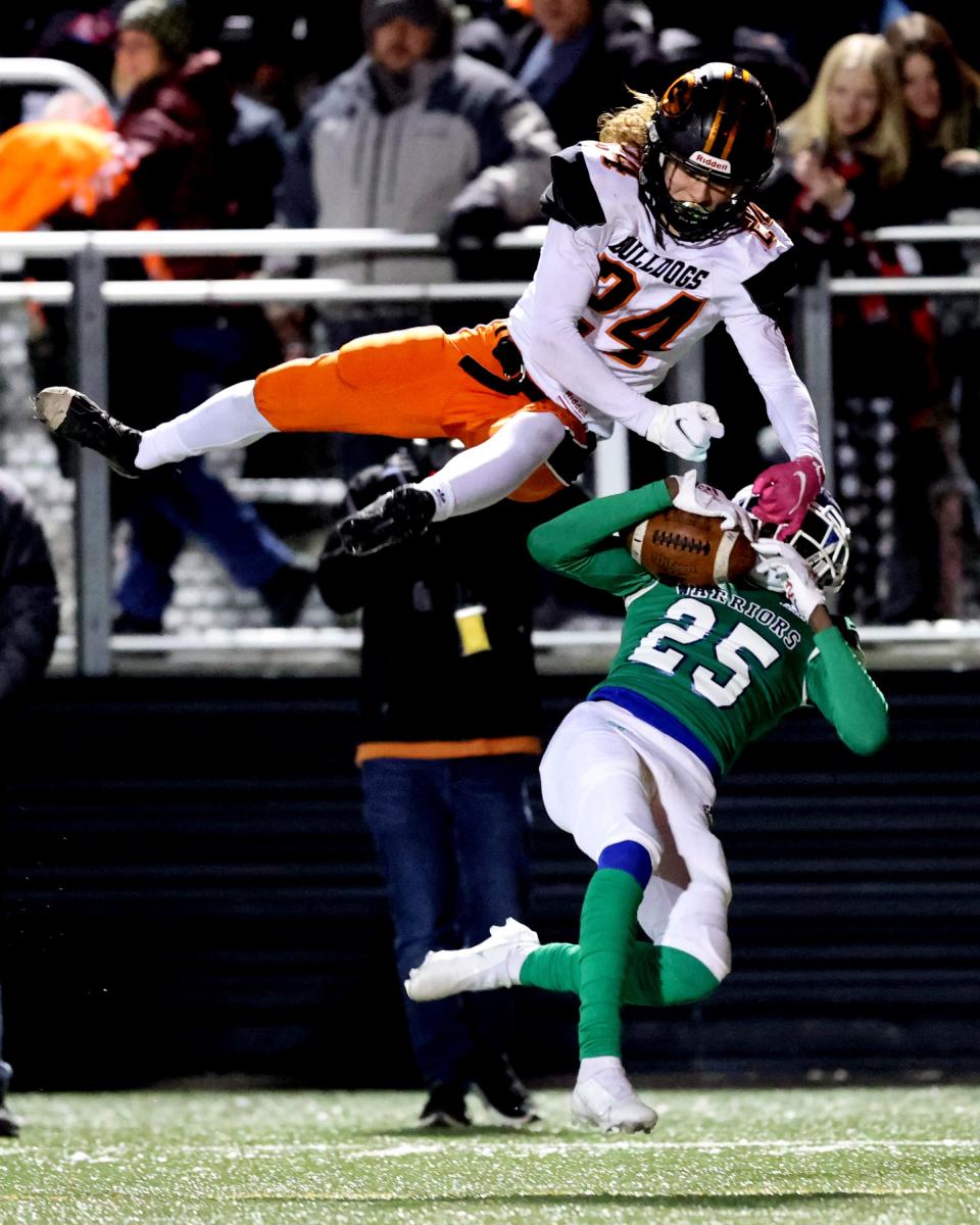 Winton Woods defensive back Cameron Calhoun intercepts a pass deep in Bulldogs territory in the OHSAA DII football state semifinal at Westerville Nov. 26, 2021.