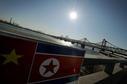 File photo of North Korean and Chinese flags beside the Yalu Bridge leading into North Korea. South Korea will seek global support at a UN meeting next week for its efforts to rescue North Korean refugees recently arrested in China and facing repatriation, according to the foreign ministry