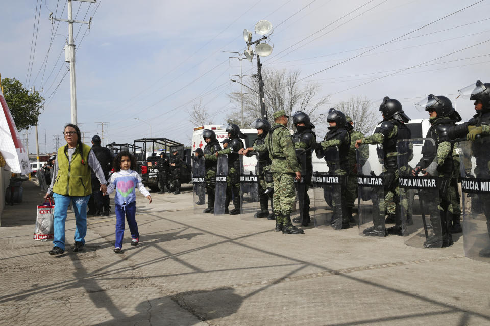 A woman arrives with donations at a shelter housing Central American immigrants in Piedras Negras, Mexico, Tuesday, Feb. 5, 2019. A caravan of about 1,600 Central American migrants camped Tuesday in the Mexican border city of Piedras Negras, just west of Eagle Pass, Texas. The governor of the northern state of Coahuila described the migrants as "asylum seekers," suggesting all had express intentions of surrendering to U.S. authorities. (Jerry Lara/The San Antonio Express-News via AP)