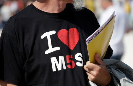 A 5-Star movement supporter wears a t-shirt reading "I love 5-Stars movement" during a gathering in Rimini, Italy, September 23, 2017. REUTERS/Max Rossi