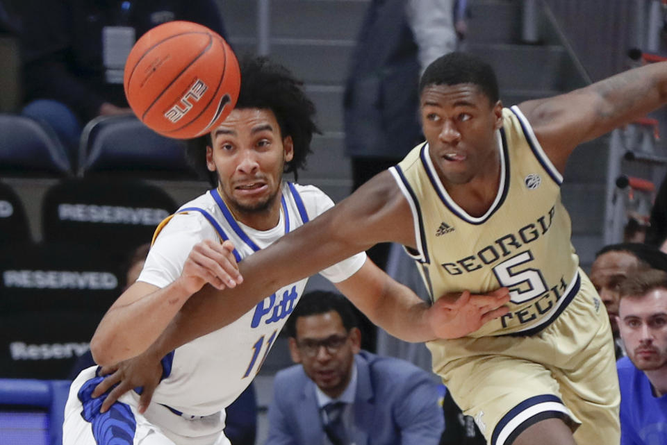 Pittsburgh's Justin Champagnie (11) and Georgia Tech's Moses Wright (5) chase after a loose ball during the first half of an NCAA college basketball game, Saturday, Feb. 8, 2020, in Pittsburgh. (AP Photo/Keith Srakocic)