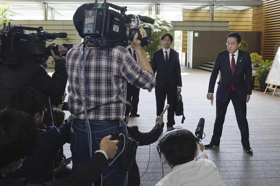 Japanese Prime Minister Fumio Kishida, right, speaks to media at the prime minister's official office in Tokyo, after North Korea launched a ballistic missile toward the sea between the Korean Peninsula and Japan on Thursday. (Kyodo News via AP)