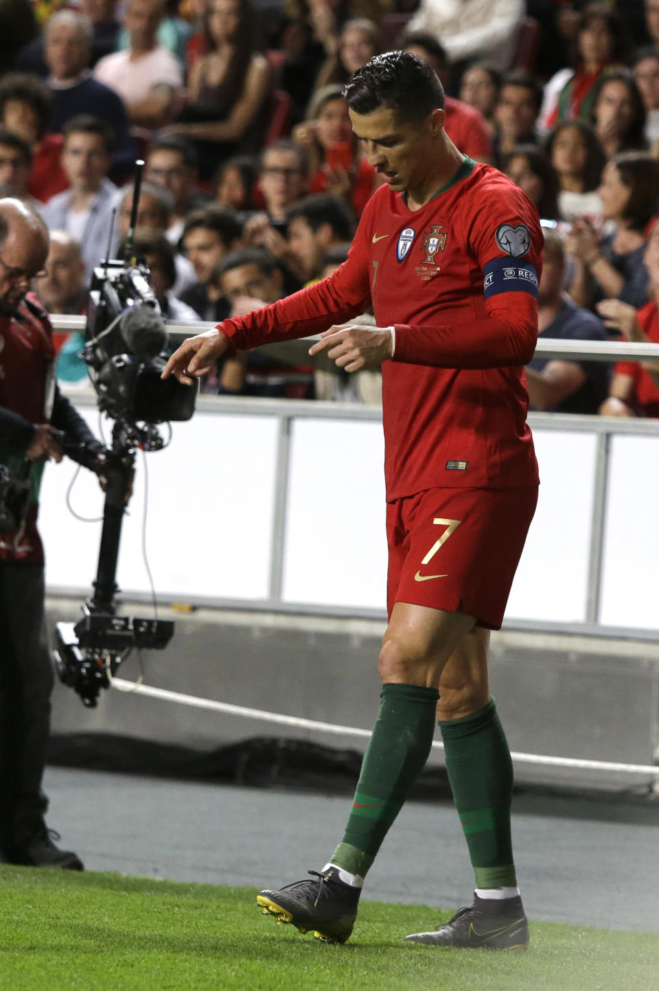 FILE - In this Monday, March 25, 2019 file photo, Portugal's Cristiano Ronaldo reacts during the Euro 2020 group B qualifying soccer match between Portugal and Serbia at the Luz stadium in Lisbon, Portugal. Juventus president Andrea Agnelli has hinted that the Bianconeri might not risk Cristiano Ronaldo for the first match of the Champions League quarterfinals against Ajax. Ronaldo injured a muscle in his right thigh and was forced off after half an hour of Portugal's 1-1 draw against Serbia in qualifying for the 2020 European Championship on Monday. (AP Photo/Armando Franca, FILE )