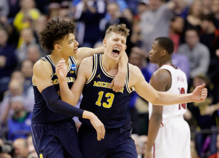 Moritz Wagner #13 of the Michigan Wolverines celebrates a shot with D.J. Wilson #5 in the second half against the Louisville Cardinals during the second round of the 2017 NCAA tournament. (Getty) 