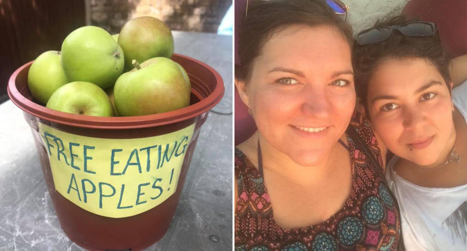 Lydia Farrell is pictured with two boxes of apples.