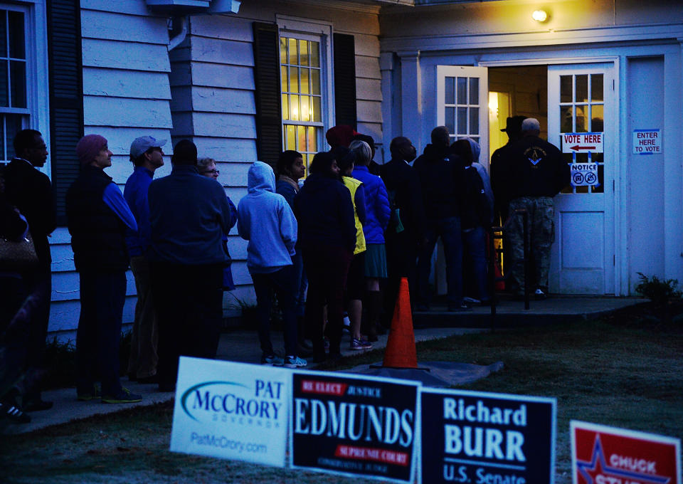 Early morning voters try to make their way inside a voting precinct to get out of the cold temperatures in Durham, North Carolina, Tuesday, on Nov. 8.