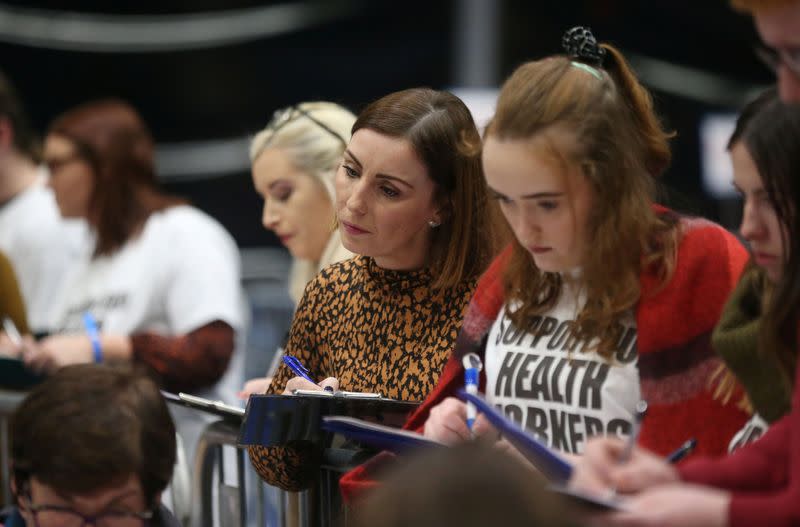 Tallymen watch as the first ballot boxes are opened at the count centre, Titanic Quarter, Belfast, Northern Ireland