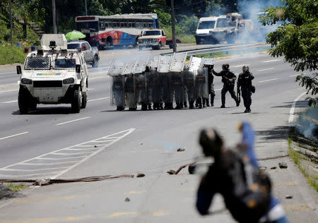 A demonstrator hurls rocks at security forces during clashes at a rally against Venezuelan President Nicolas Maduro's government in Caracas, Venezuela, July 18, 2017. REUTERS/Andres Martinez Casares