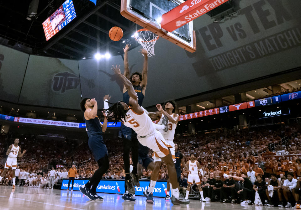 Texas guard Marcus Carr (5) shoots over UTEP forward Calvin Solomon during the first half an NCAA college basketball game Monday, Nov. 7, 2022, in Austin, Texas. (AP Photo/Michael Thomas)