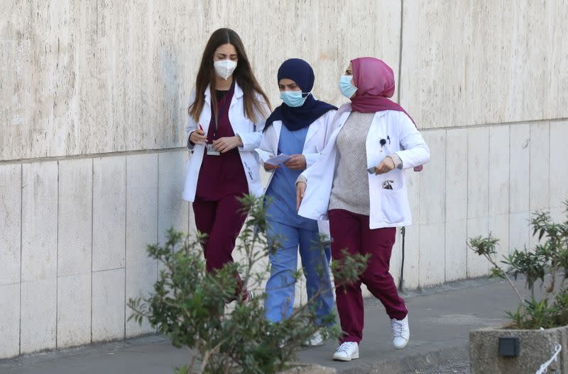 Health workers wearing face masks walk outside American University of Beirut's (AUB) medical centre, amid the coronavirus disease (COVID-19) outbreak in Beirut