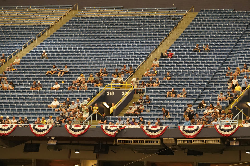 Fans watch amongst empty seats during Game 2 in an AL wild-card baseball playoff series between the Tampa Bay Rays and the Texas Rangers, Wednesday, Oct. 4, 2023, in St. Petersburg, Fla. (AP Photo/John Raoux)