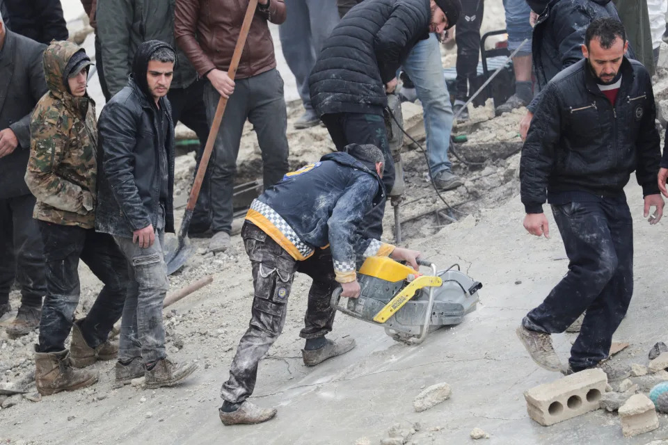 People gather as rescuers search for survivors under the rubble, following an earthquake, in rebel-held town of Jandaris, Syria February 6, 2023. (Khalil Ashawi/Reuters)