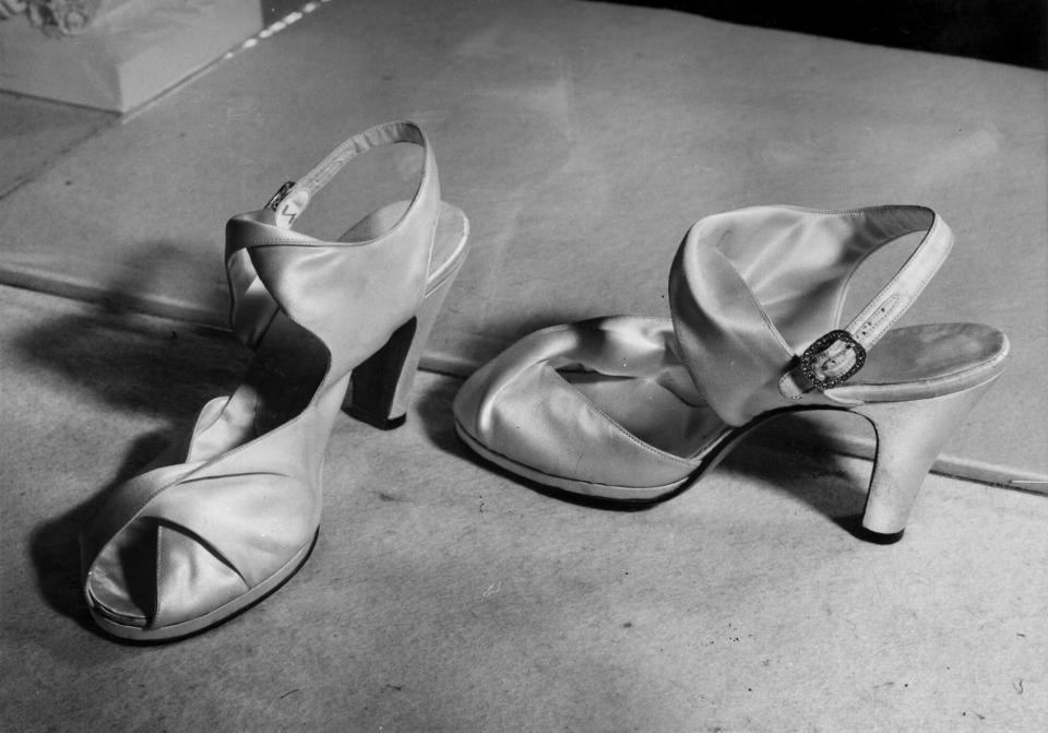 A close-up of the wedding shoes of Princess Elizabeth, 'Ivory Duchess' satin self-lined sandals designed by Rayne. The buckles are silver, studded with small pearls