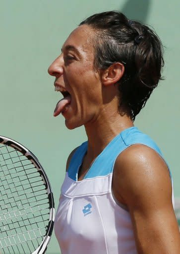 Italy's Francesca Schiavone sticks her tongue as she plays against America's Varvara Lepchenko during their women's singles third round match at the French Open. Schiavone lost 3-6, 6-3, 8-6 to Lepchenko