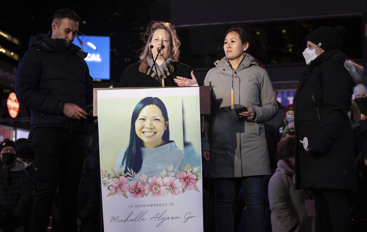 Friends of Michelle Alyssa Go speak during a candlelight vigil.