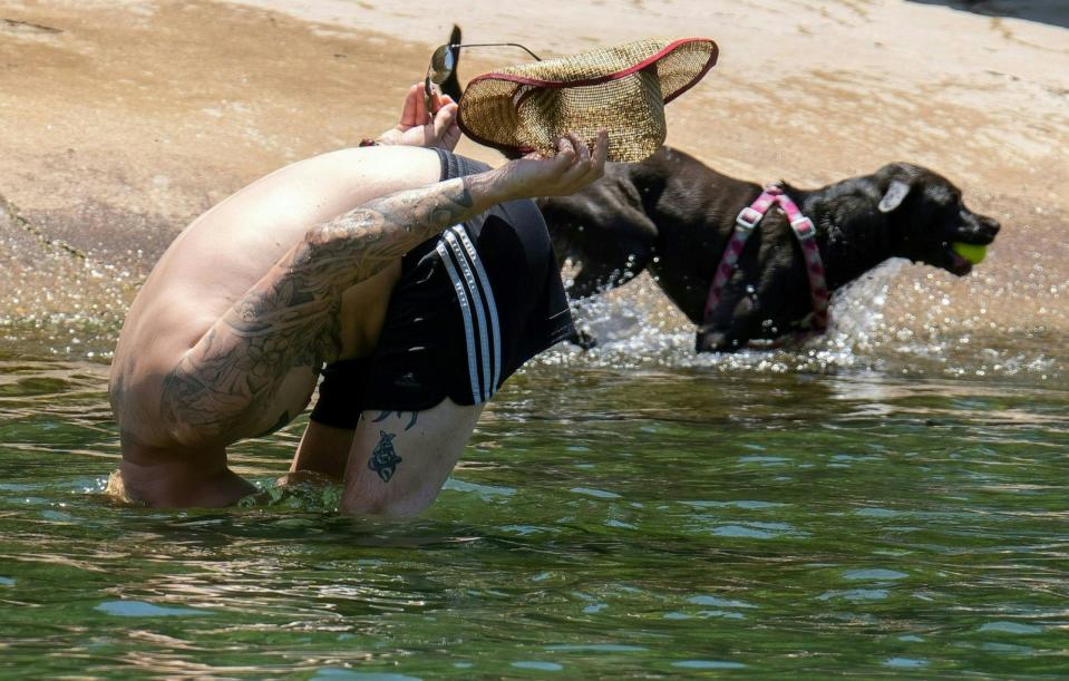 PHOTO: A man dunks his head to cool off in Barton Creek Pool on June 27, 2023 in Austin, Texas. (Suzanne Cordeiro/AFP via Getty Images)