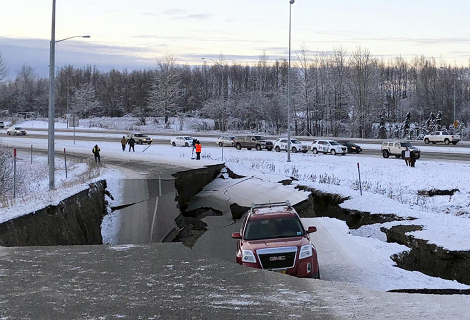 A vehicle is trapped on a section of road that collapsed during an earthquake in Anchorage, Alaska. (Photo: Dan Joling/Associated Press)