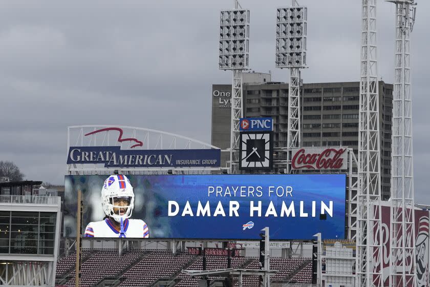 A scoreboard at Great American Ballpark displays a photo of Buffalo Bills' Damar Hamlin, Tuesday, Jan. 3, 2023, in Cincinnati. Hamlin was taken to the University of Cincinnati Medical Center after collapsing on the field during an NFL football game against the Cincinnati Bengals on Monday night.(AP Photo/Darron Cummings)