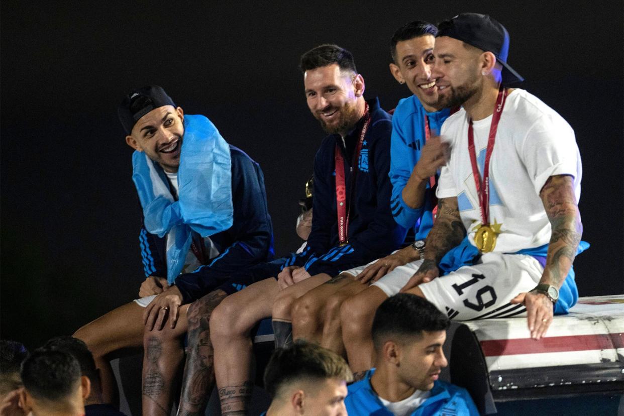 Captain Lionel Messi, send from left, sits with Angel de Maria, second from right, and Nicolas Otamendi, right, atop of a bus driving the players from the Argentine soccer team that won the World Cup after they landed at Ezeiza airport on the outskirts of Buenos Aires, Argentina Wcup Soccer, Buenos Aires, Argentina - 20 Dec 2022