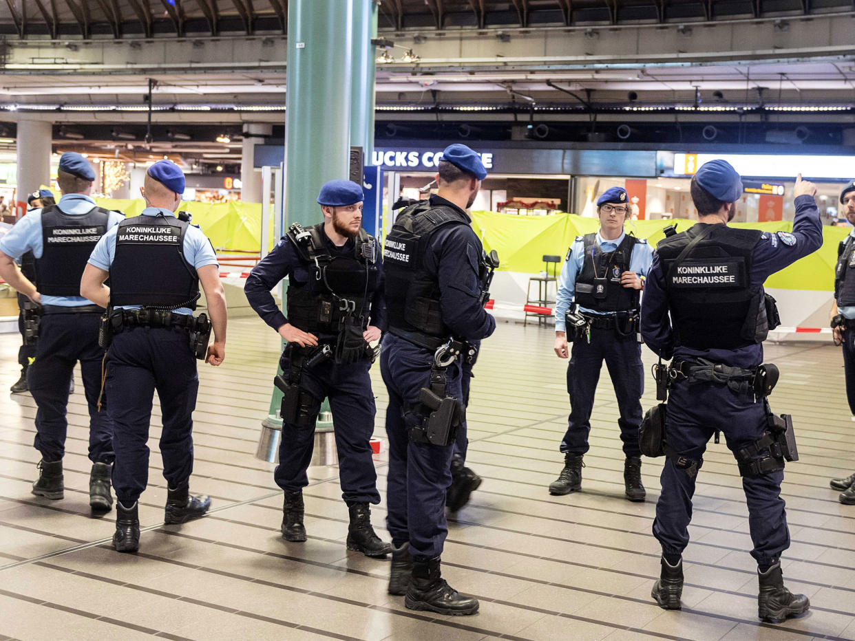 Amsterdam's international airport was evacuated after police shot a suspect who was allegedly threatening passengers with a knife: EPA