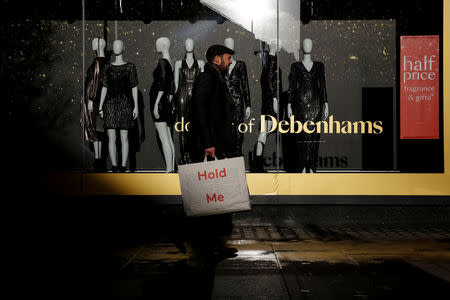 FILE PHOTO: Shoppers walk past a window display at the Debenhams department store on Oxford Street in London, Britain December 17, 2018. REUTERS/Simon Dawson/File Photo