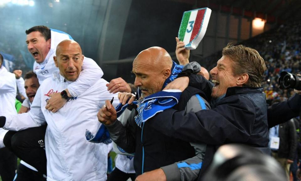 A stunned Luciano Spalletti is mobbed by Napoli staff after the final whistle against Udinese.