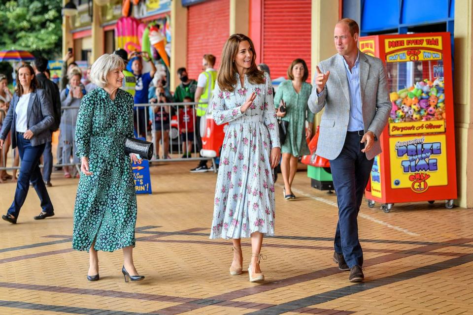 <p>For a visit to South Wales, Kate chose an Emilia Wickstead belted, floral midi dress. She paired the look with brown suede espadrilles and, when she was indoors, her liberty print face mask. Luckily, the dress proved flexible enough for Kate to engage in some <a href="https://www.townandcountrymag.com/society/tradition/a33521295/kate-middleton-prince-william-arcade-games-barry-island-video-photos/" rel="nofollow noopener" target="_blank" data-ylk="slk:intense arcade games;elm:context_link;itc:0;sec:content-canvas" class="link ">intense arcade games</a>. </p>