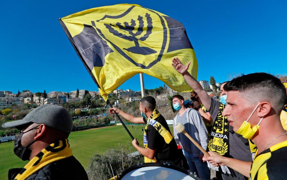  Fans of Israeli Beitar Jerusalem football club show their support during the team's training in Jerusalem on December 11, 2020, after a member of Abu Dhabi's royal family bought half of Beitar. - AFP