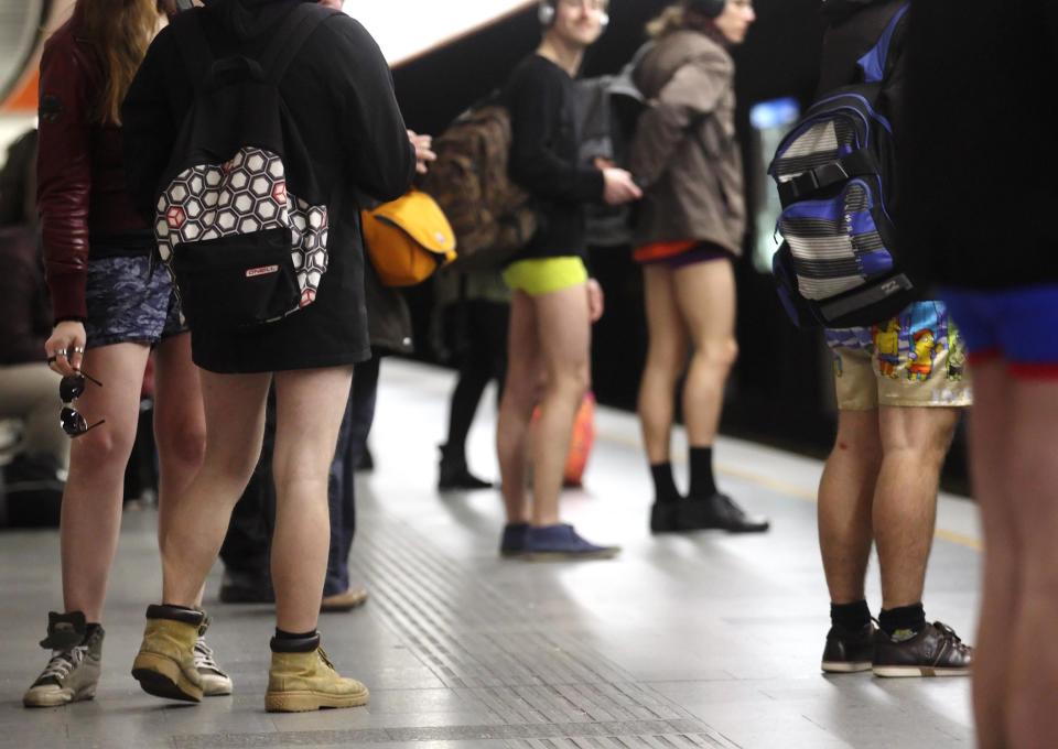 Passengers without their pants wait on a underground platform during the "No Pants Subway Ride" in Vienna