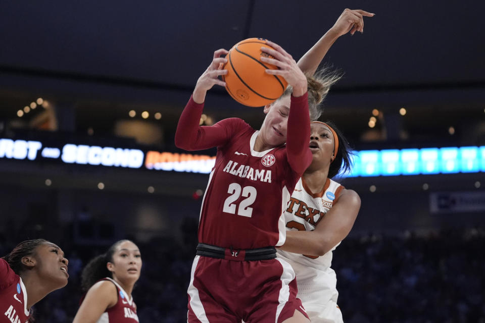 Alabama guard Karly Weathers (22) grabs a rebound in front of Texas forward Aaliyah Moore, right, during the first half of a second-round college basketball game in the women’s NCAA Tournament in Austin, Texas, Sunday, March 24, 2024. (AP Photo/Eric Gay)