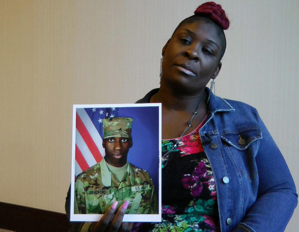 In this still image taken from video, April Pipkins holds a photograph of her deceased son, Emantic "EJ" Bradford Jr., during an interview in Birmingham, Ala., on Tuesday, Nov. 27, 2018. Bradford was shot to death by a police officer in a shopping mall on Thanksgiving night, and Pipkins said she believes her son would still be alive had he been white. (AP Photo/Jay Reeves)