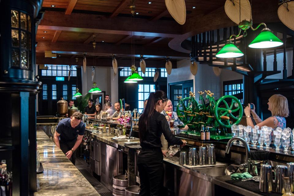 This photo taken on January 25, 2019 shows a bar staff preparing the "Singapore Sling" cocktail for customers at a bar in Singapore. - The Singapore Sling, synonymous with the city-state's rich history, has been shaken up to give the drink a new lease of life but still faces challenges in a crowded cocktail market. (Photo by Theodore LIM / AFP) / TO GO WITH STORY Singapore-lifestyle-tourism-drink story        (Photo credit should read THEODORE LIM/AFP via Getty Images)